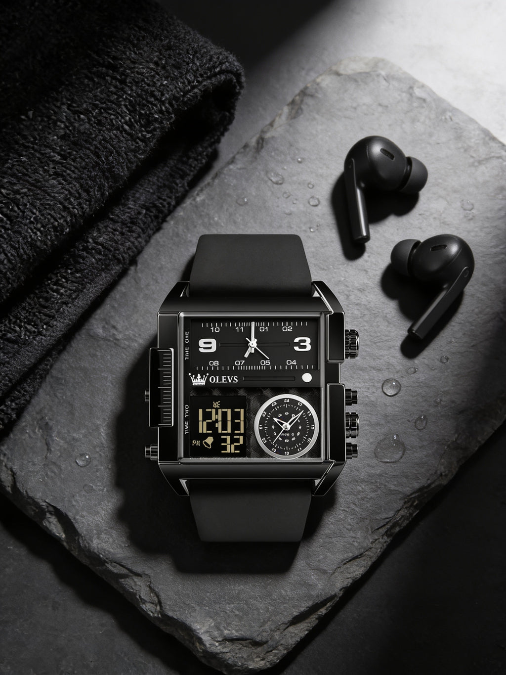 OLEVS black square analog-digital watch flat-lay on slate with gym towel and earbuds