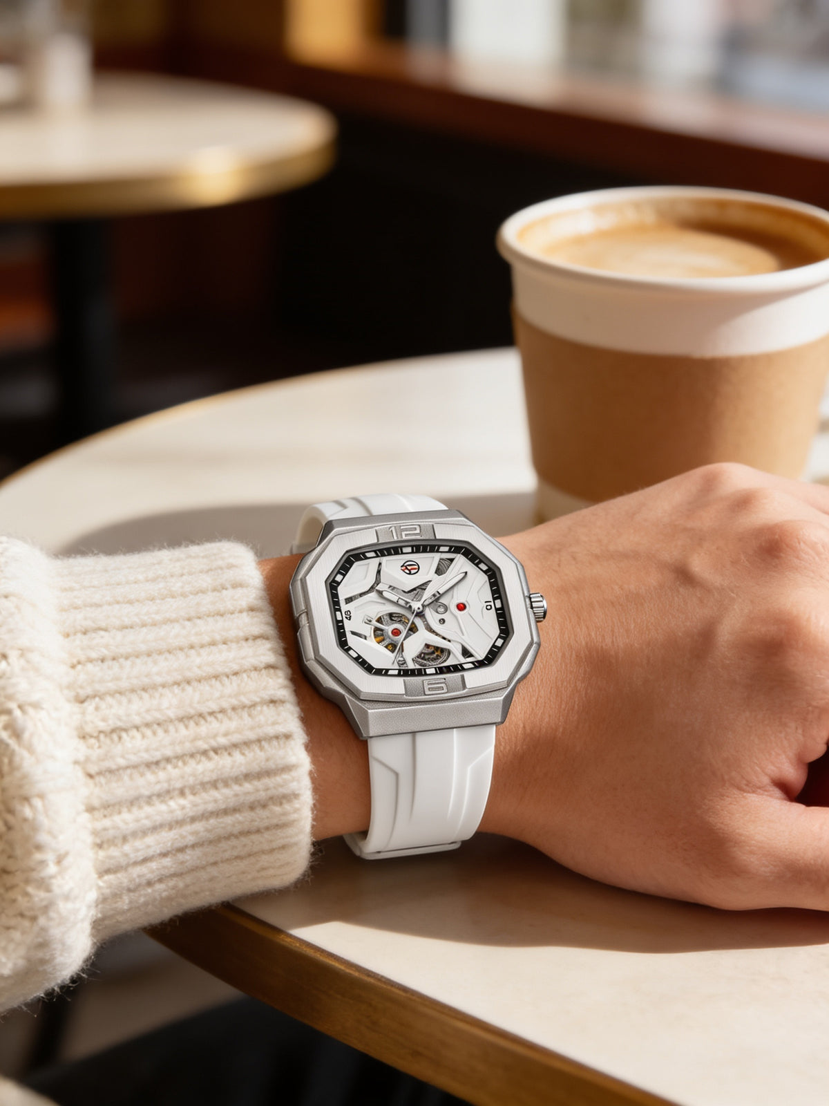 FORSINING 452A skeleton automatic watch worn on wrist at a cafe