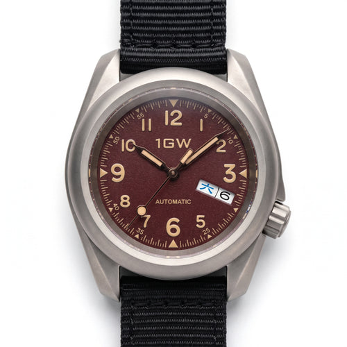 1GW Burgundy Field Day-Date Titanium 40mm - straight-on studio hero on white, burgundy textured dial, cream numerals, day-date at 3