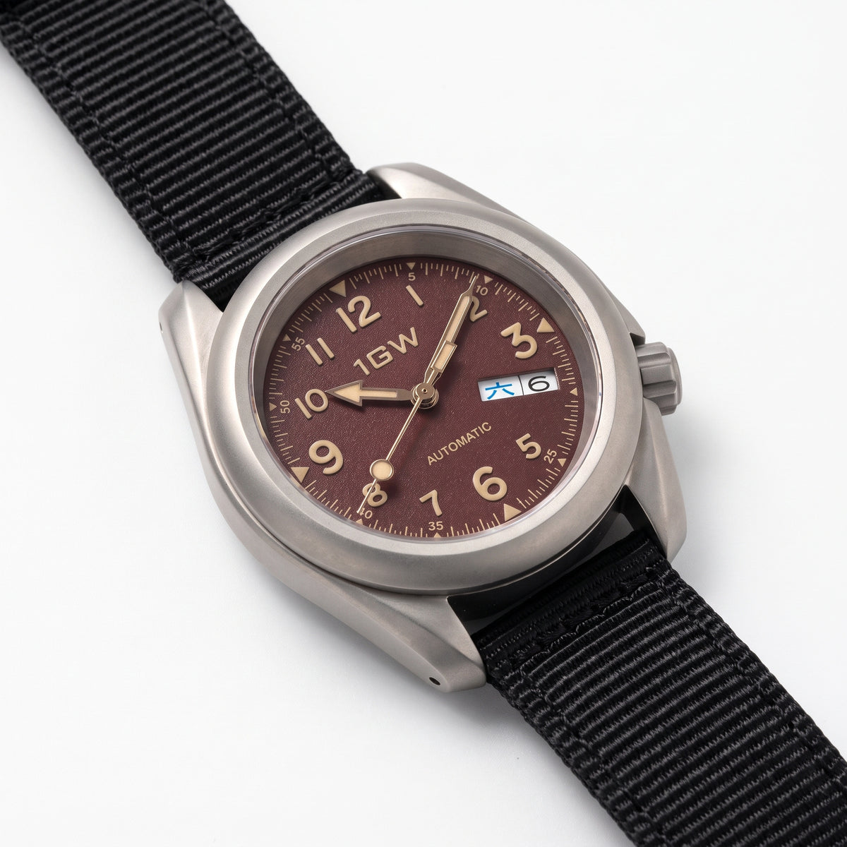 1GW Burgundy Field Day-Date Titanium 40mm - high three-quarter studio angle on white showing titanium case side, crown and lug profile