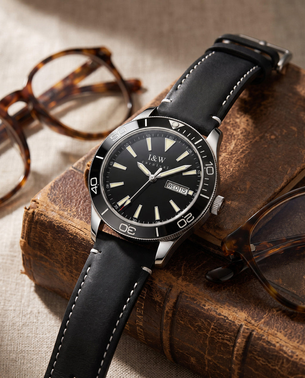 Carnival I&W IW.533G automatic watch on vintage books beside glasses, branded dial