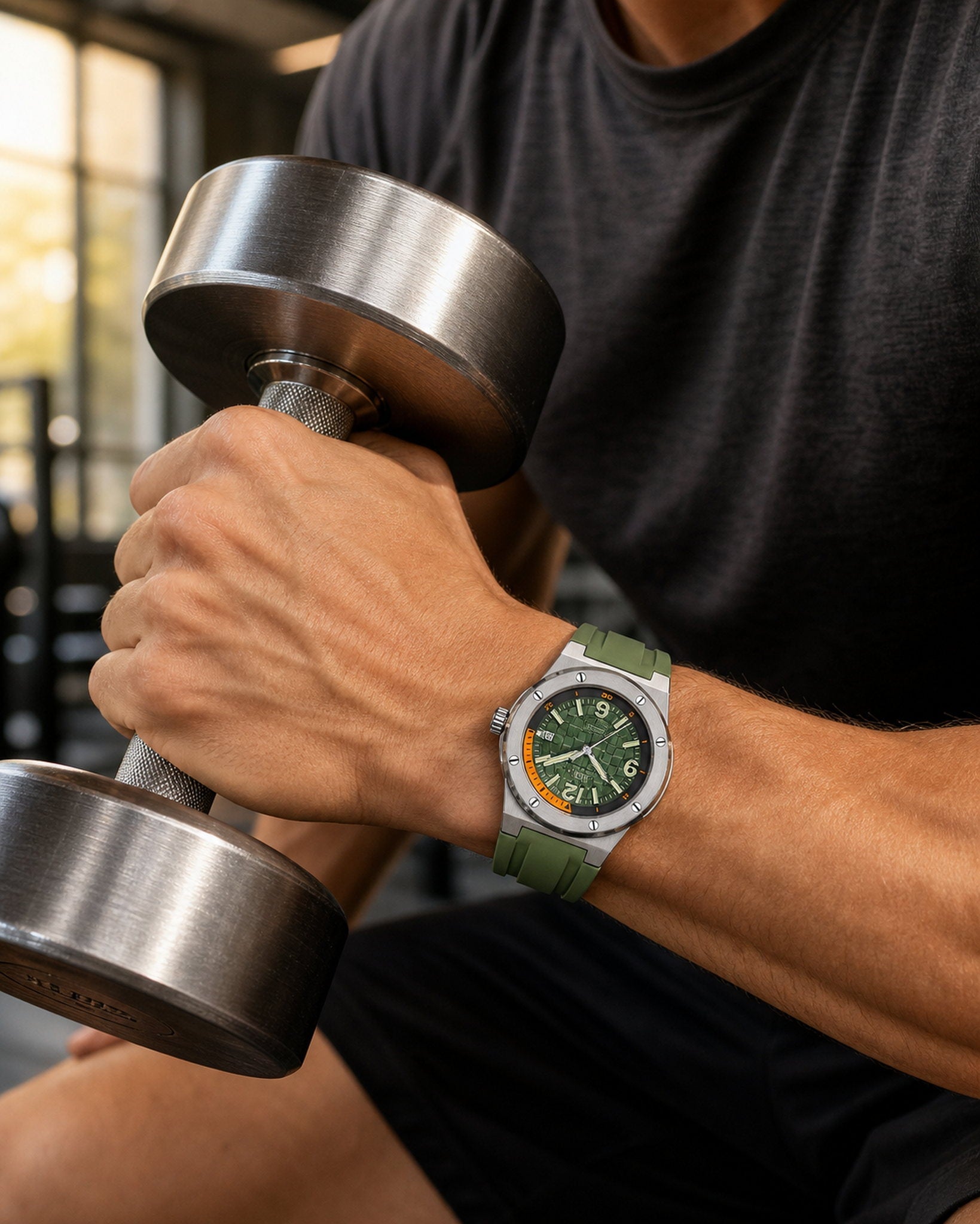 Carnival I&W IW.618G green automatic watch worn while gripping a dumbbell in a gym