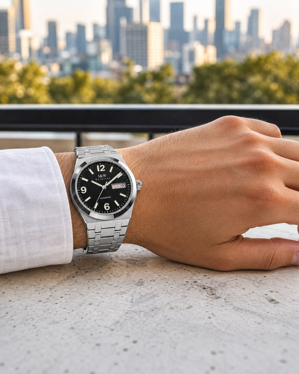 Carnival black day-date automatic watch on wrist on a city balcony