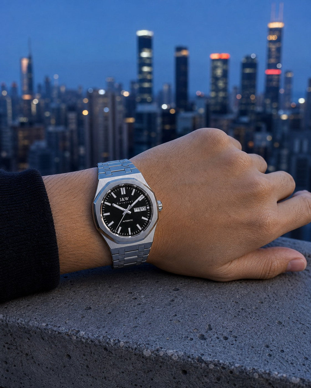 Carnival black-dial integrated-bracelet automatic watch on wrist at blue hour