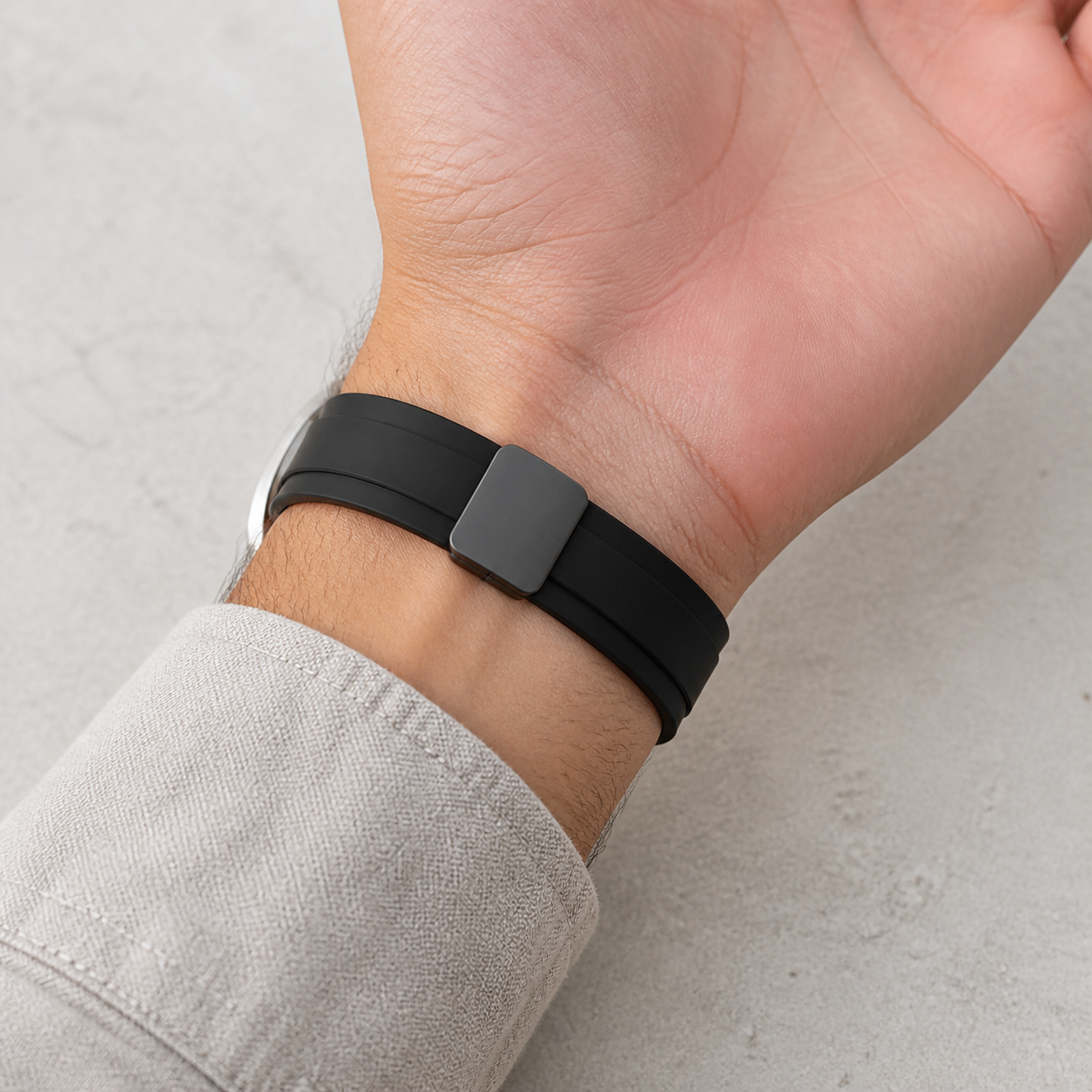 Black magnetic silicone strap metal clasp on the underside of the wrist