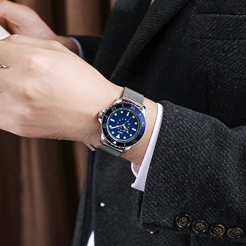 TPW K5013 blue dial watch with silver mesh bracelet worn with a dark coat