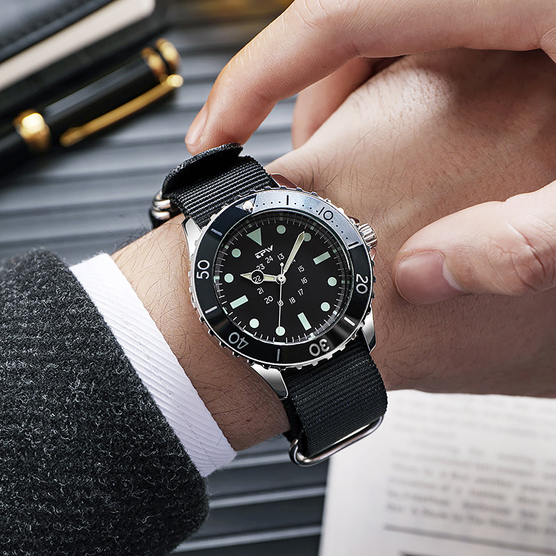 TPW K5013 black dial watch with black nylon strap worn at a desk