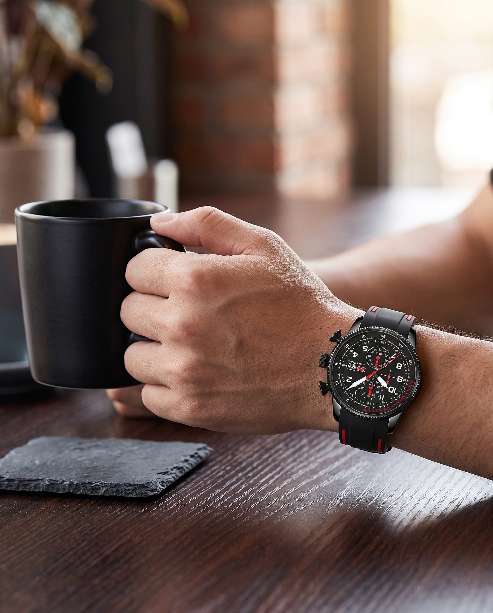 MINI FOCUS 0379G Black and Red chronograph worn while holding a coffee mug