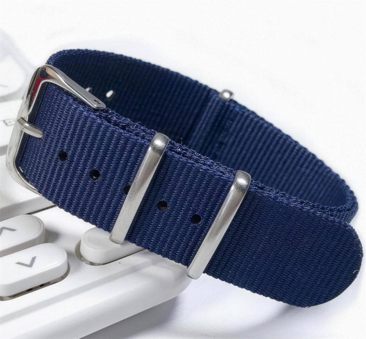 Navy blue woven nylon pass-through watch strap with brushed steel keepers and pin buckle