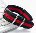 Black and red striped woven nylon pass-through watch strap, coiled to show the weave