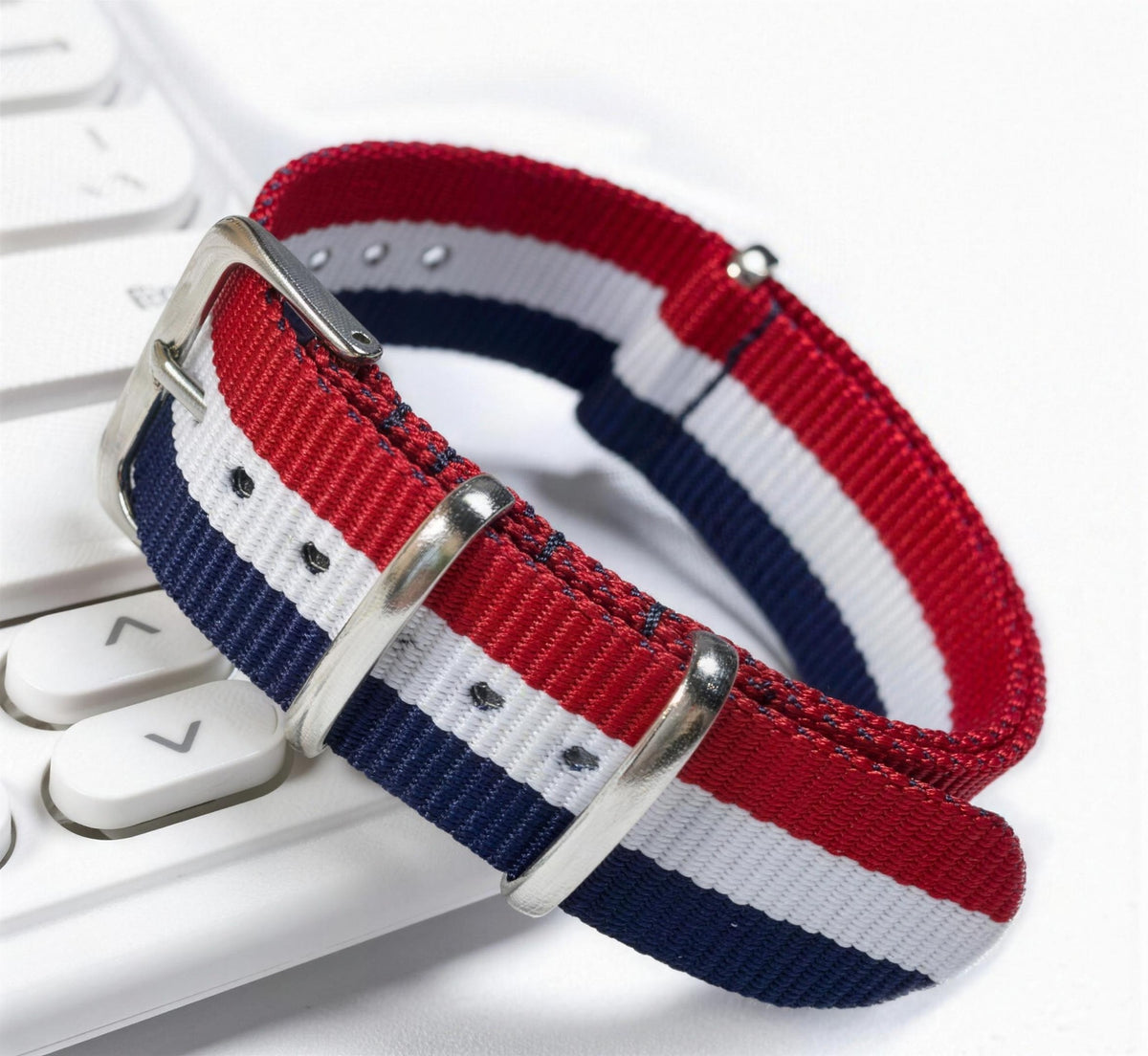 Red, navy and white striped woven nylon pass-through watch strap with brushed steel keepers