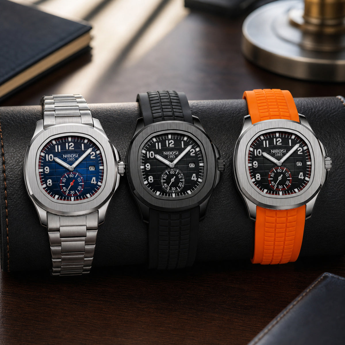 Three NIBOSI 2653 watches with steel, black silicone, and orange silicone bands on an executive desk