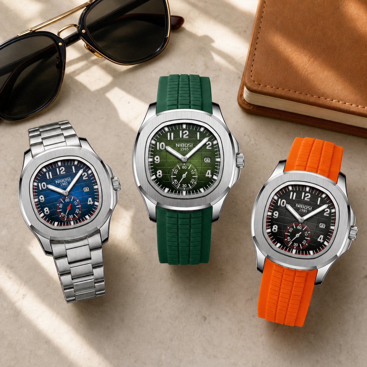 Three NIBOSI 2653 watches with steel, green silicone, and orange silicone bands in a travel flat lay