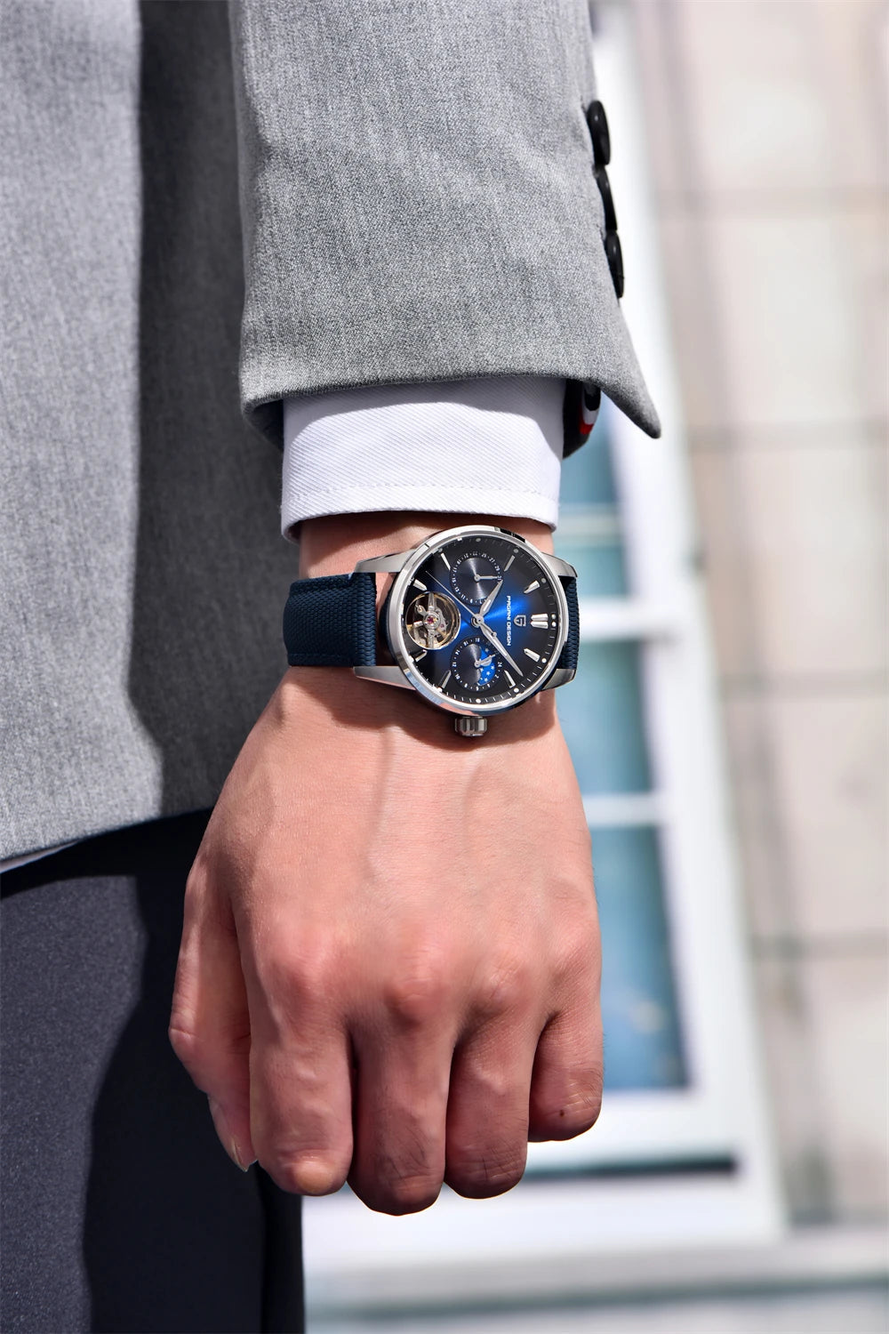 Pagani Design YS021 blue dial automatic watch worn with a gray suit