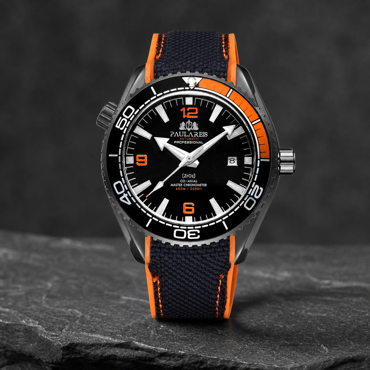Paulareis black and orange sport automatic watch displayed on stone
