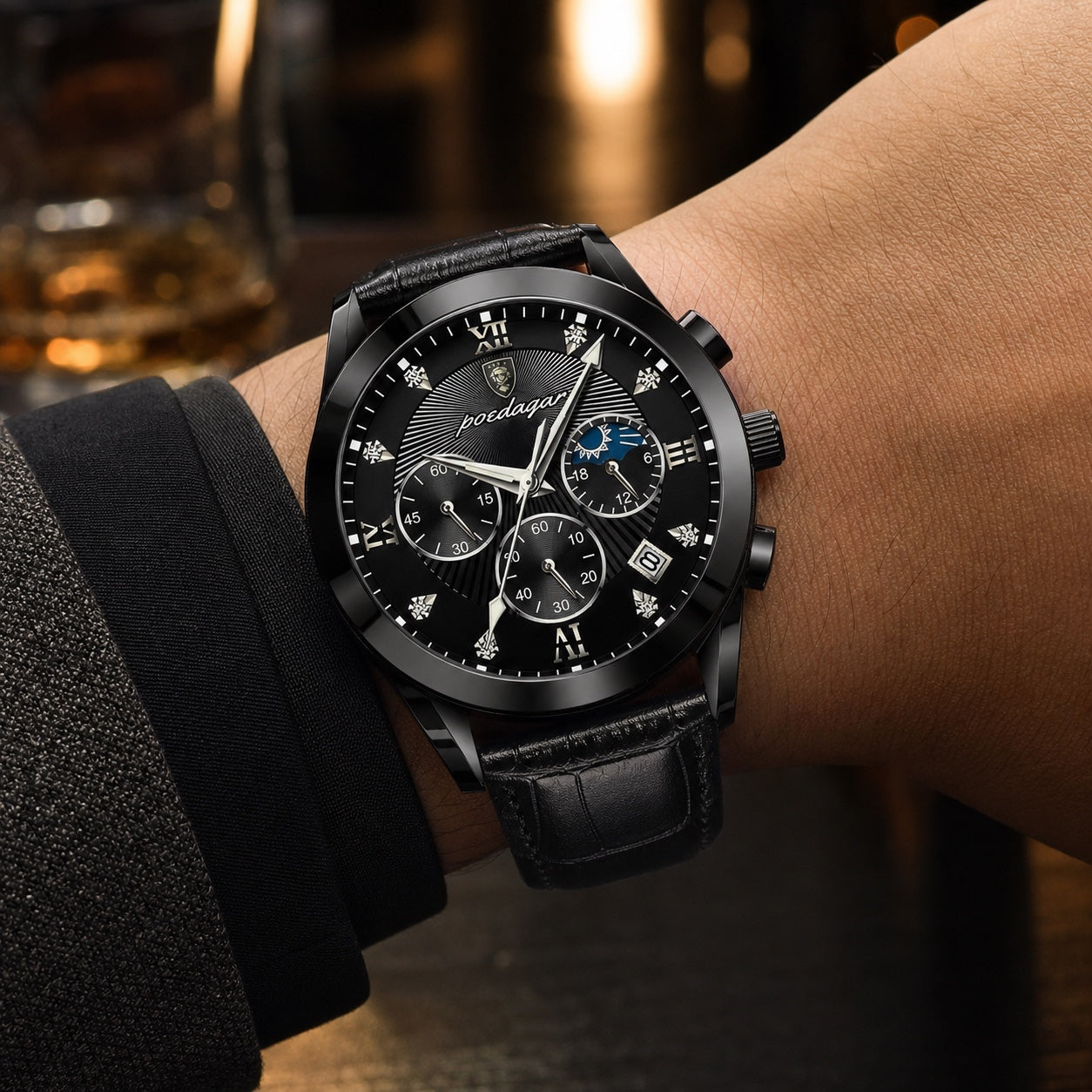 POEDAGAR black-case black-dial chronograph with black leather strap worn in an evening lounge