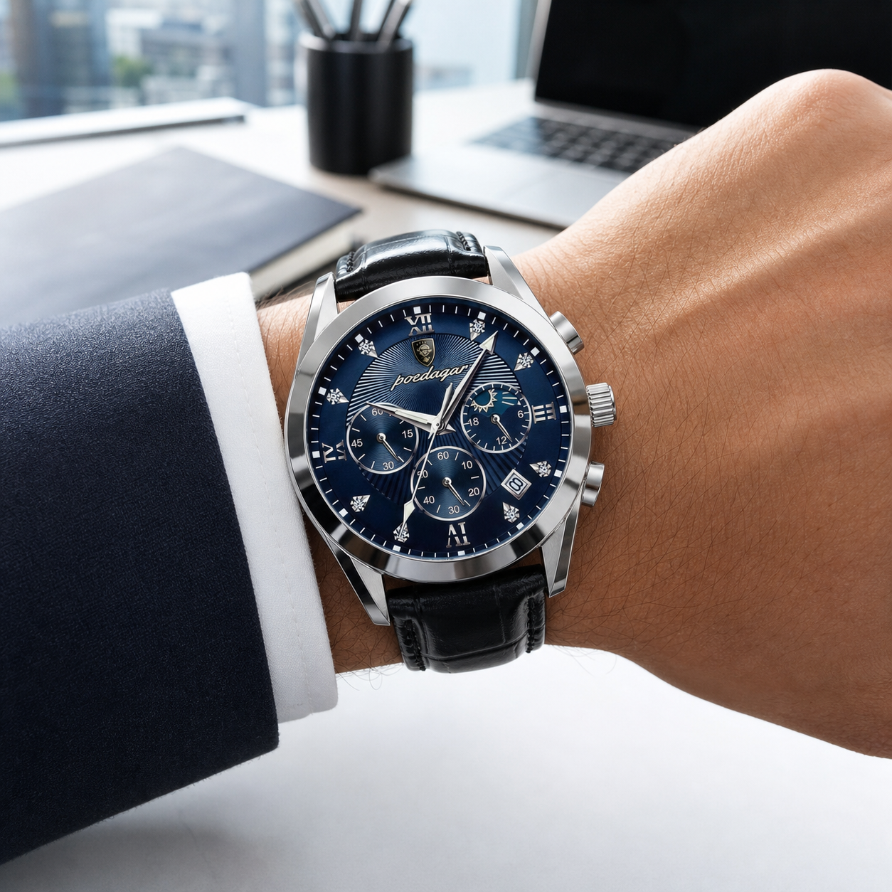 POEDAGAR silver-case blue-dial chronograph with black leather strap worn in a modern office