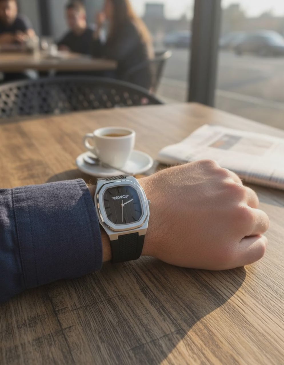AWC square watch in black worn at an outdoor cafe table