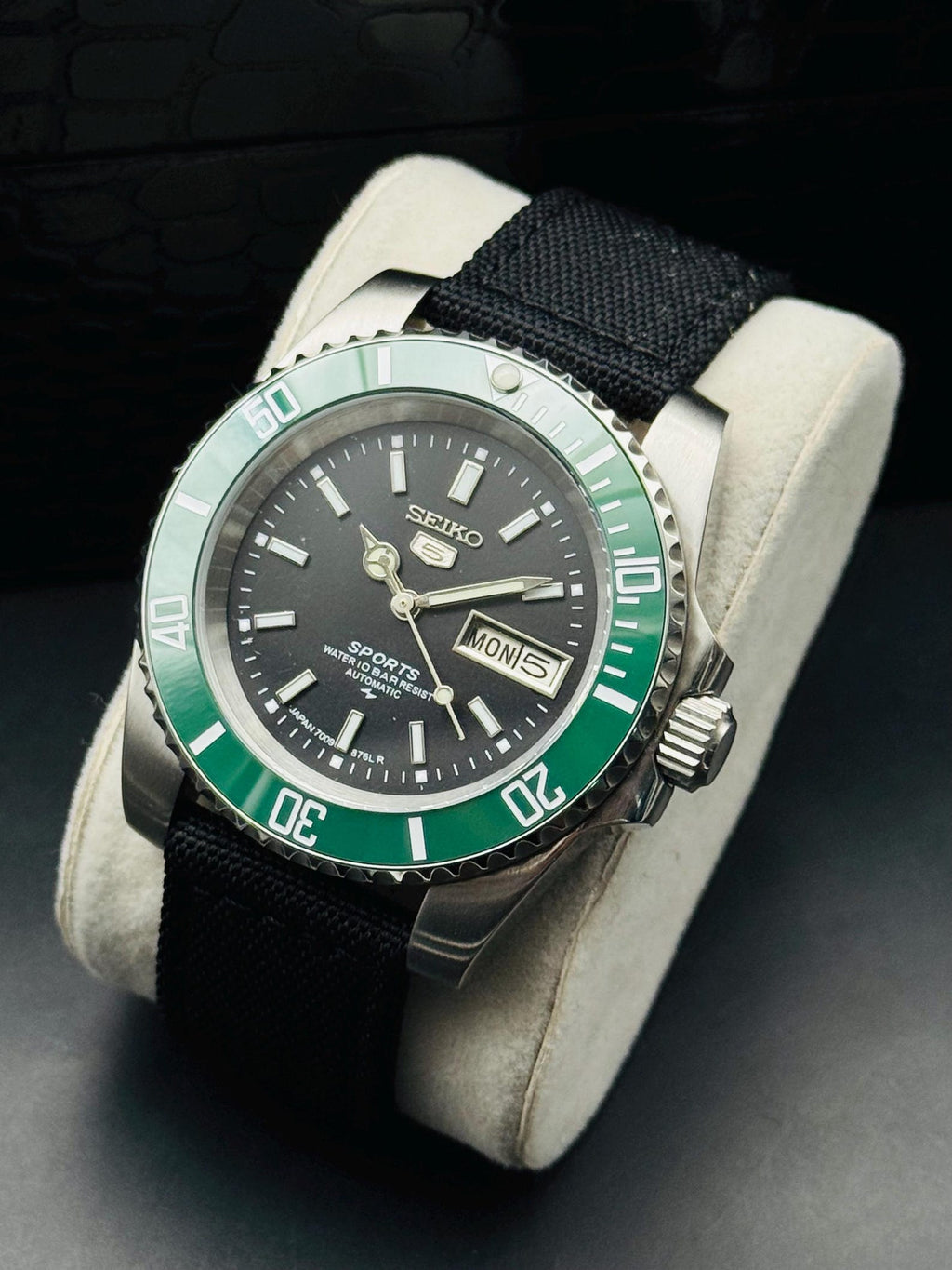 Seller-refurbished Seiko 5 Sports automatic with black dial, green bezel and black nylon strap