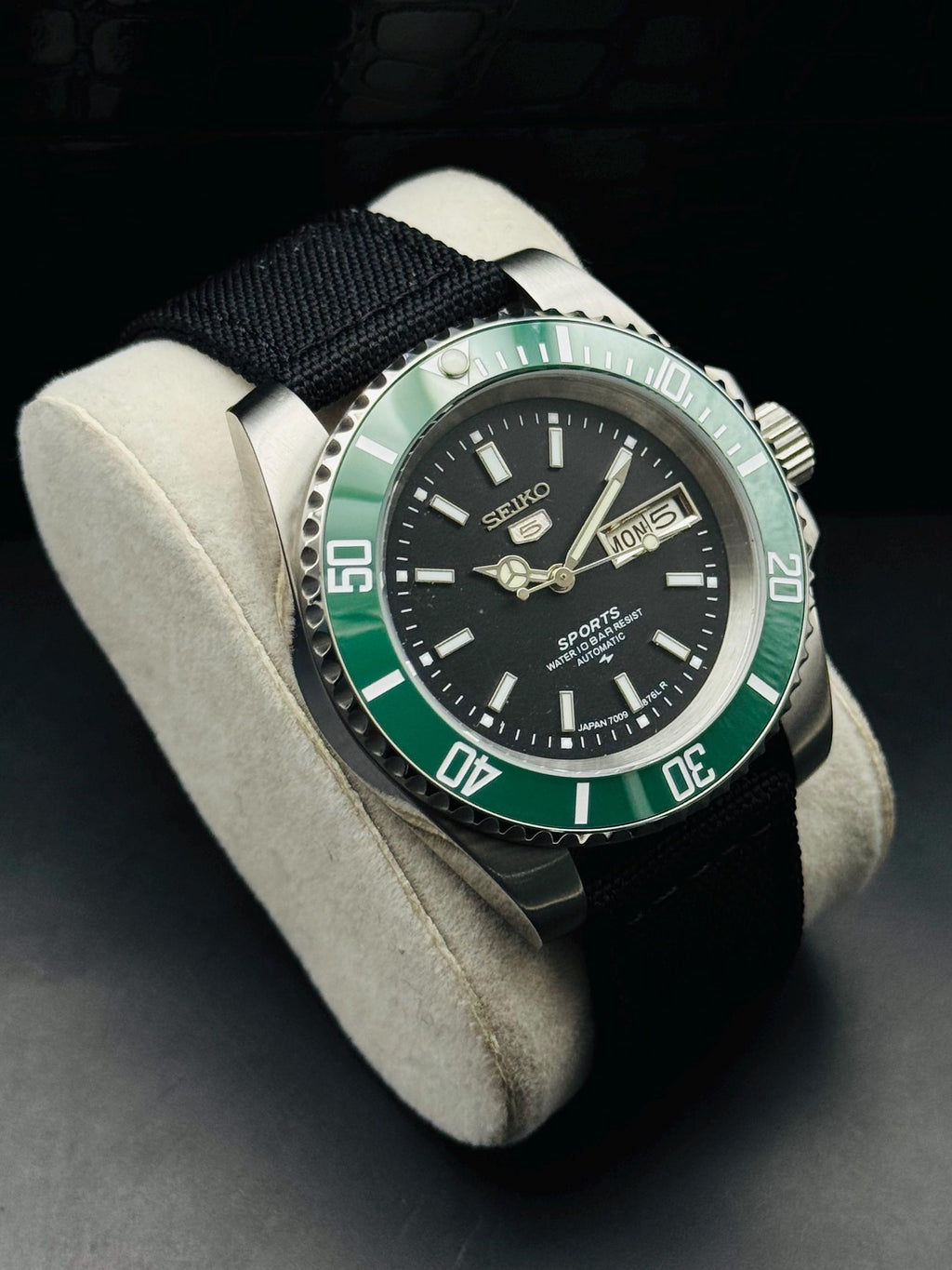 Angled view of vintage Seiko 5 Sports black-dial automatic watch