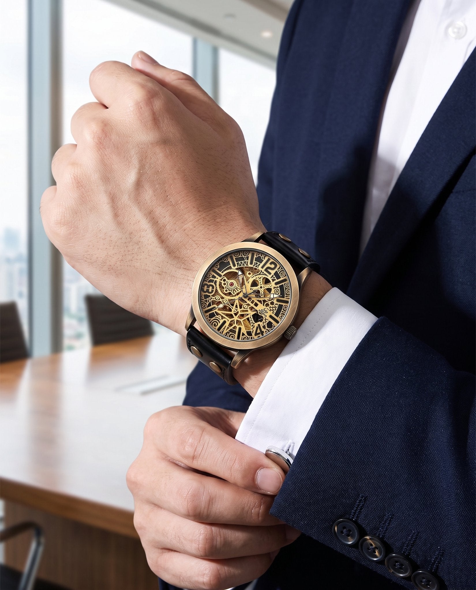 Man in a navy blazer wearing the Shenhua bronze skeleton automatic watch