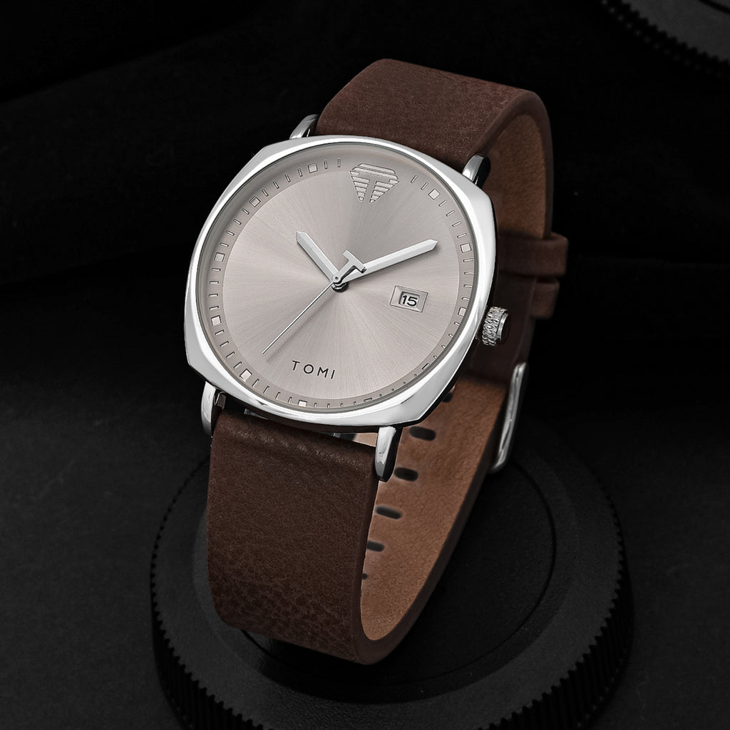 TOMI minimalist calendar quartz watch with silver case, silver dial, and brown leather strap