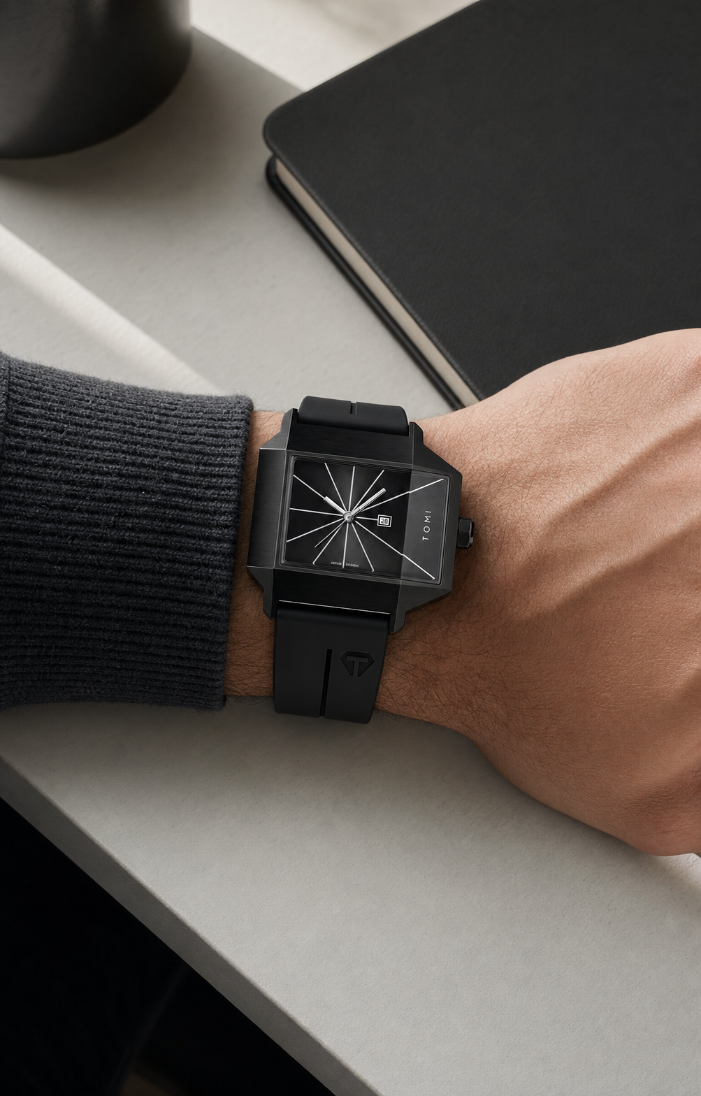 TOMI T021 black square watch worn at a modern desk